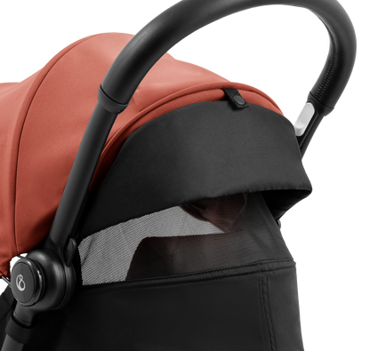 A compact yoyo 5 stroller with a rust-orange canopy and seat lining, a black frame, and black wheels, shown on a plain white background.