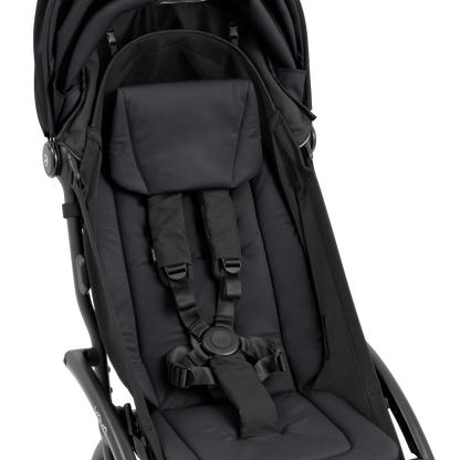 A compact yoyo 5 stroller with a black canopy and seat lining, a black frame, and black wheels, shown on a plain white background.