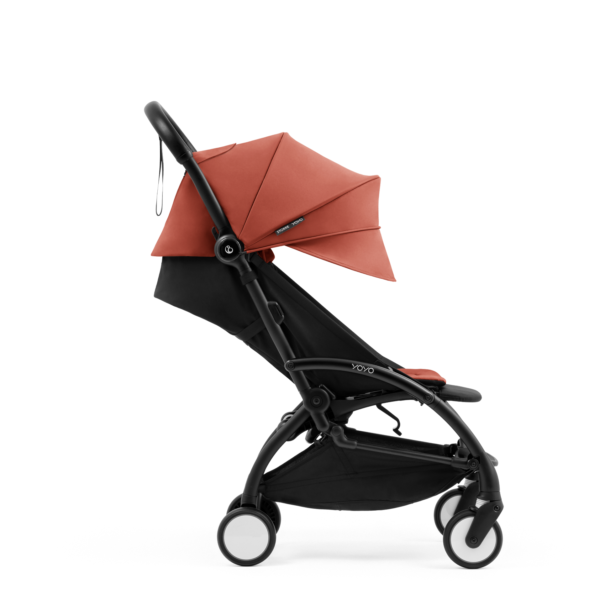 A compact yoyo 5 stroller with a rust-orange canopy and seat lining, a black frame, and black wheels, shown on a plain white background.