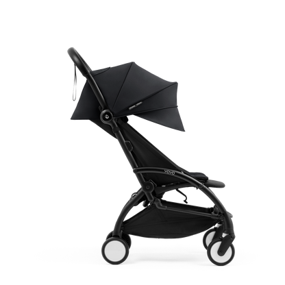 A compact yoyo 5 stroller with a black canopy and seat lining, a black frame, and black wheels, shown on a plain white background.