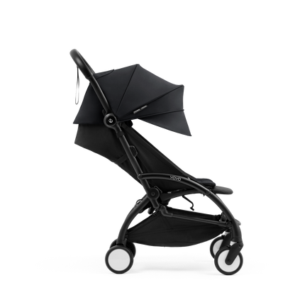 A compact yoyo 5 stroller with a black canopy and seat lining, a black frame, and black wheels, shown on a plain white background.
