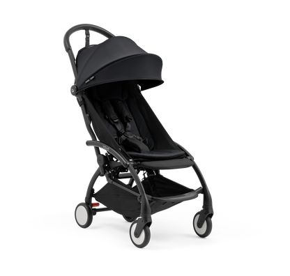 A compact yoyo 5 stroller with a black canopy and seat lining, a black frame, and black wheels, shown on a plain white background.