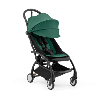 A compact yoyo 5 stroller with a green canopy and seat lining, a black frame, and black wheels, shown on a plain white background.