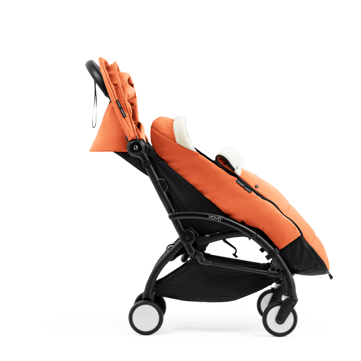 A stroller with a orange colored padded footmuff, cream fleece lining, and a black frame, shown from the front on a white background.
