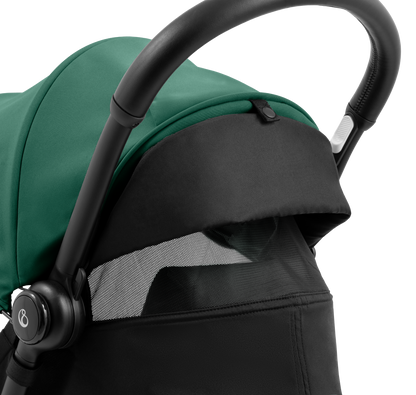 A compact yoyo 5 stroller with a green canopy and seat lining, a black frame, and black wheels, shown on a plain white background.