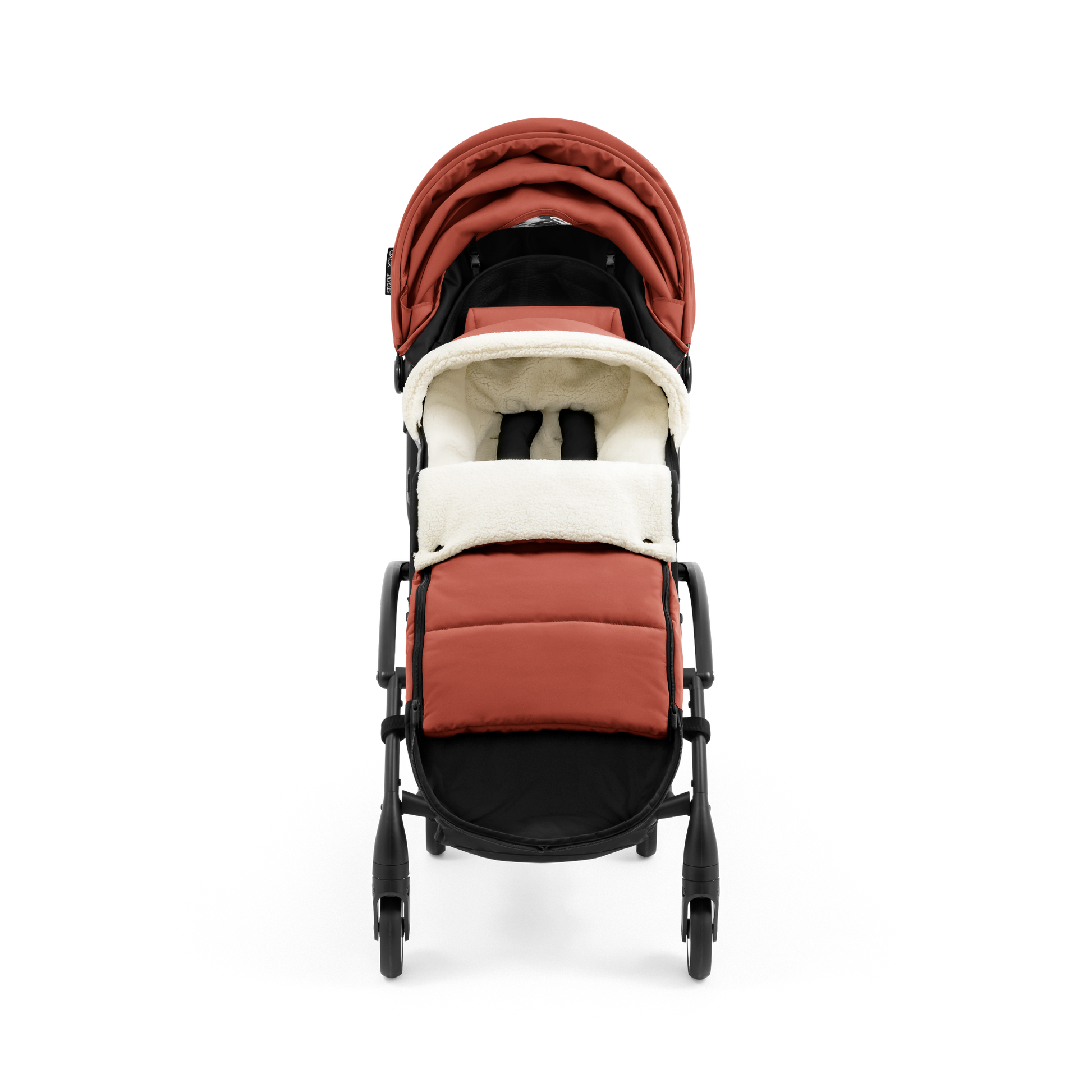 A stroller with a rust-colored padded footmuff, cream fleece lining, and a black frame, shown from the front on a white background.
