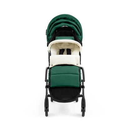 A stroller with a forest green colored padded footmuff, cream fleece lining, and a black frame, shown from the front on a white background.