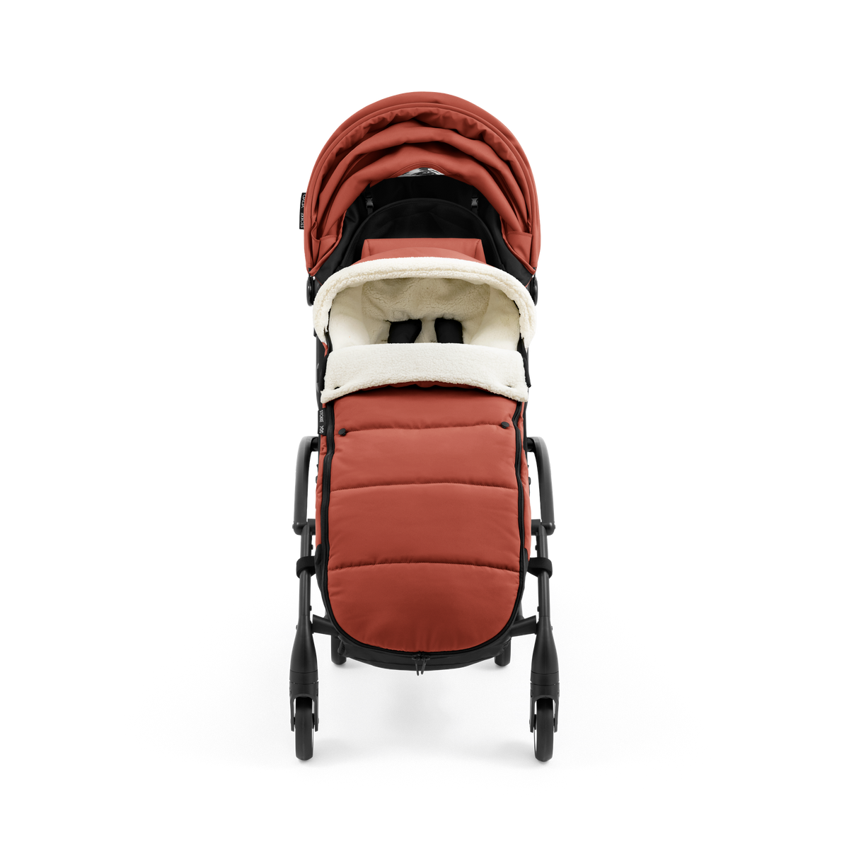 A stroller with a rust-colored padded footmuff, cream fleece lining, and a black frame, shown from the front on a white background.