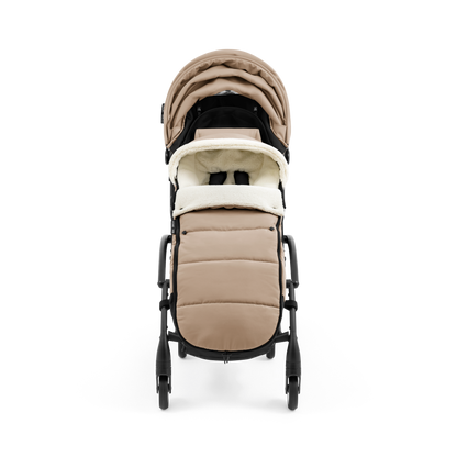 A stroller with a beige colored padded footmuff, cream fleece lining, and a black frame, shown from the front on a white background.