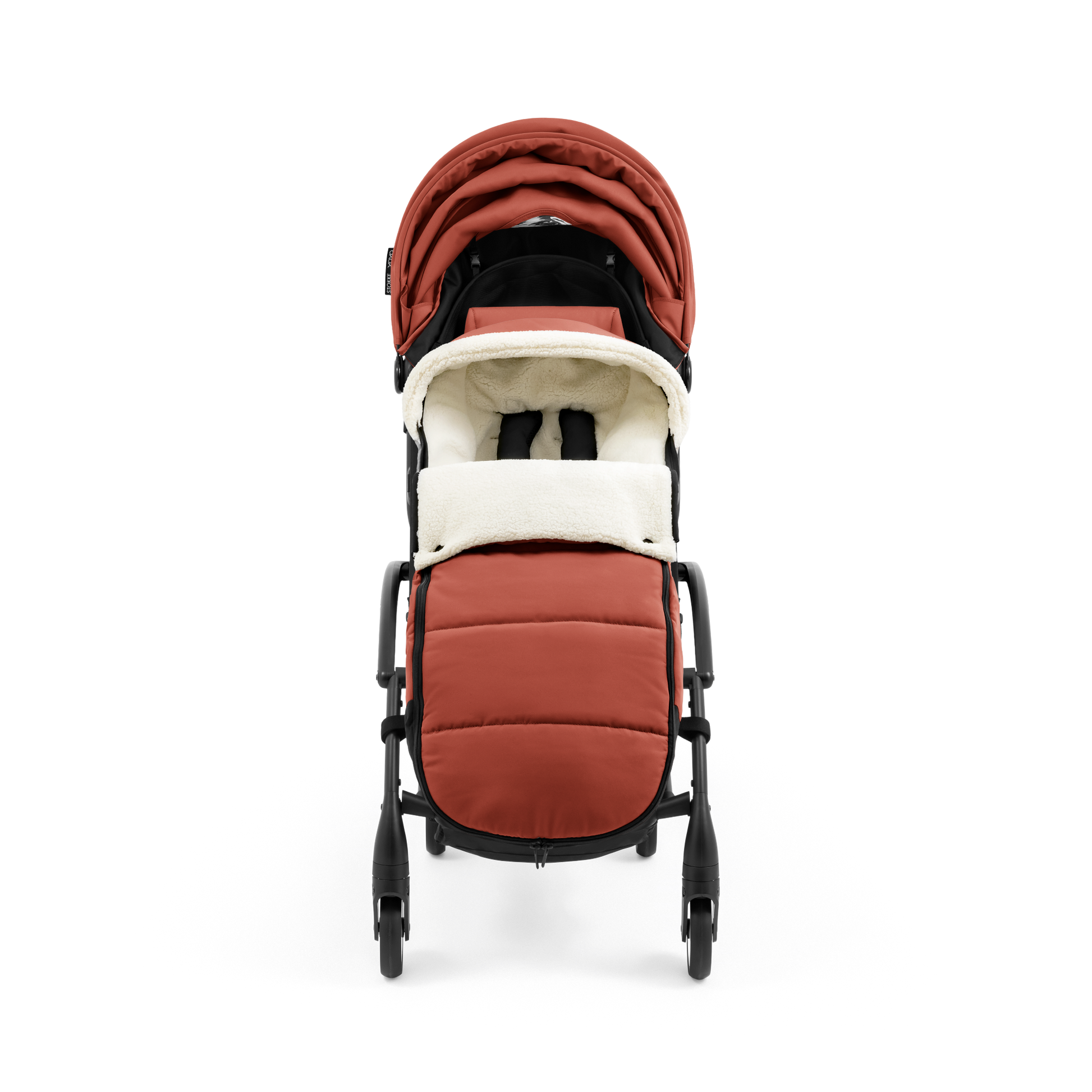 A stroller with a rust-colored padded footmuff, cream fleece lining, and a black frame, shown from the front on a white background.