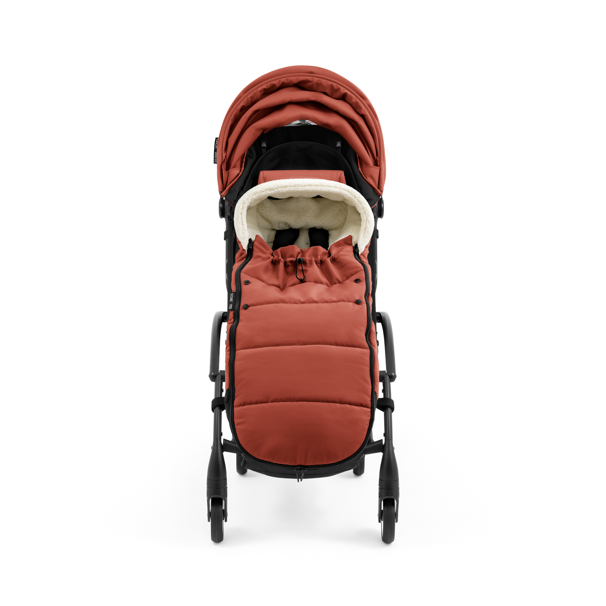 A stroller with a rust-colored padded footmuff, cream fleece lining, and a black frame, shown from the front on a white background.