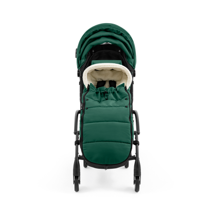 A stroller with a forest green colored padded footmuff, cream fleece lining, and a black frame, shown from the front on a white background.