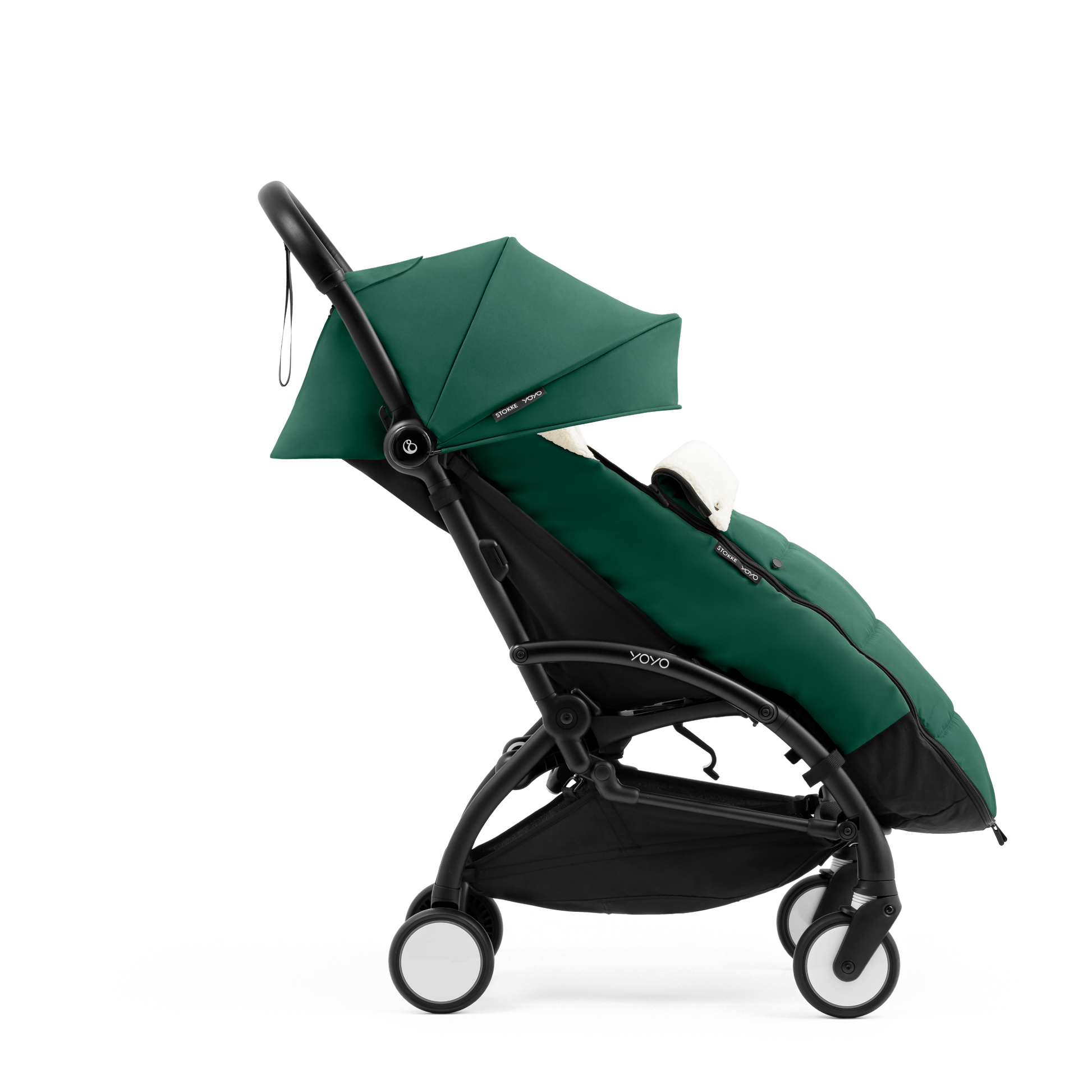 A stroller with a forest green colored padded footmuff, cream fleece lining, and a black frame, shown from the front on a white background.