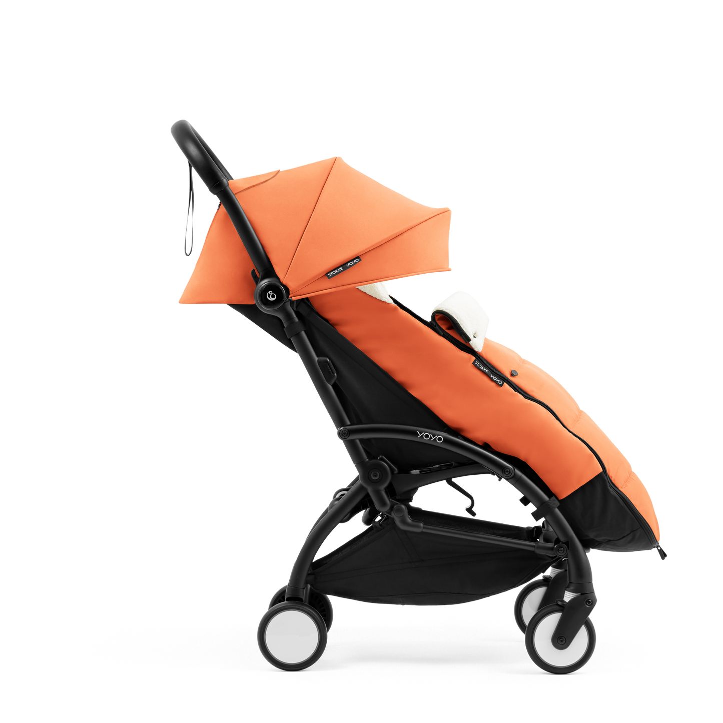 A stroller with a orange colored padded footmuff, cream fleece lining, and a black frame, shown from the front on a white background.