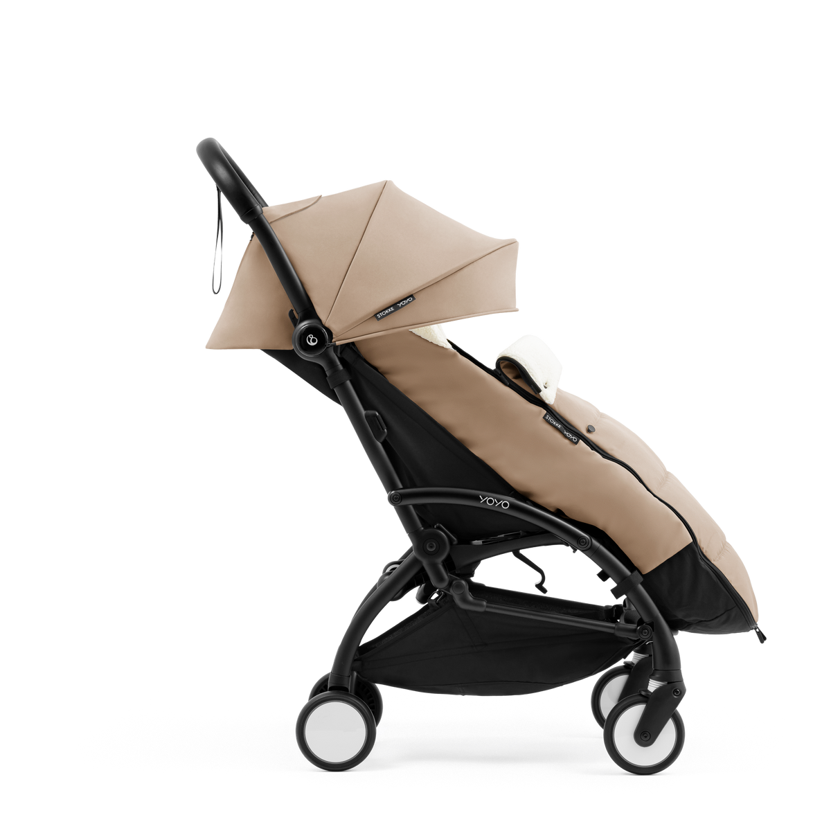 A stroller with a beige colored padded footmuff, cream fleece lining, and a black frame, shown from the front on a white background.