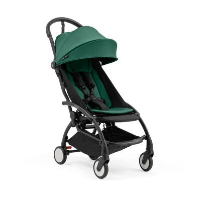 A compact yoyo 5 stroller with a green canopy and seat lining, a black frame, and black wheels, shown on a plain white background.