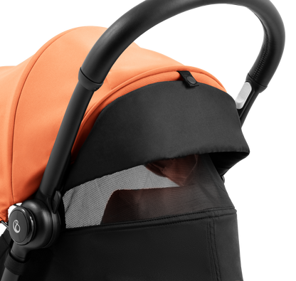 A compact yoyo 5 stroller with a peach orange canopy and seat lining, a black frame, and black wheels, shown on a plain white background.