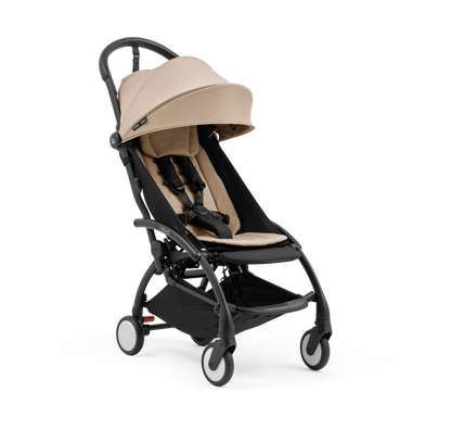 A compact yoyo 5 stroller with a beige canopy and seat lining, a black frame, and black wheels, shown on a plain white background.