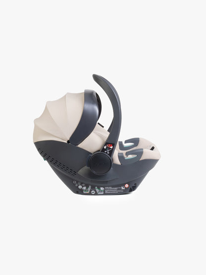 Beige baby car seat with base and ISOFIX connector on a white background