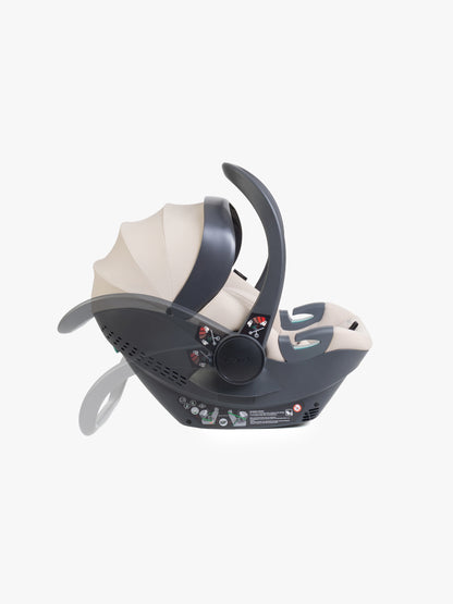 Beige baby car seat with base and ISOFIX connector on a white background