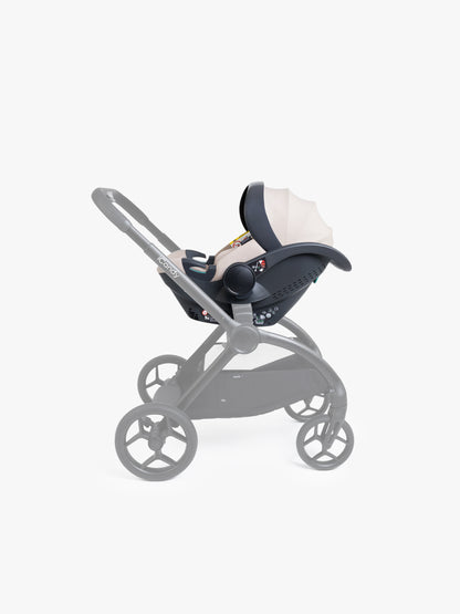 Beige baby car seat with base and ISOFIX connector on a white background