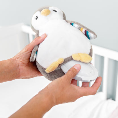 A beige and white bird with night light and soothing sounds, illustrating how to remove the sleep husher machine from inside its belly.