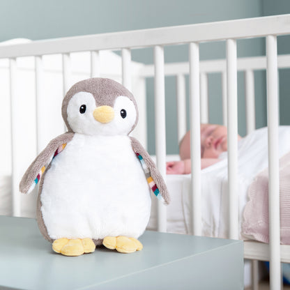 A beige and white bird with night light and soothing sounds, while baby sleeps in their cot.