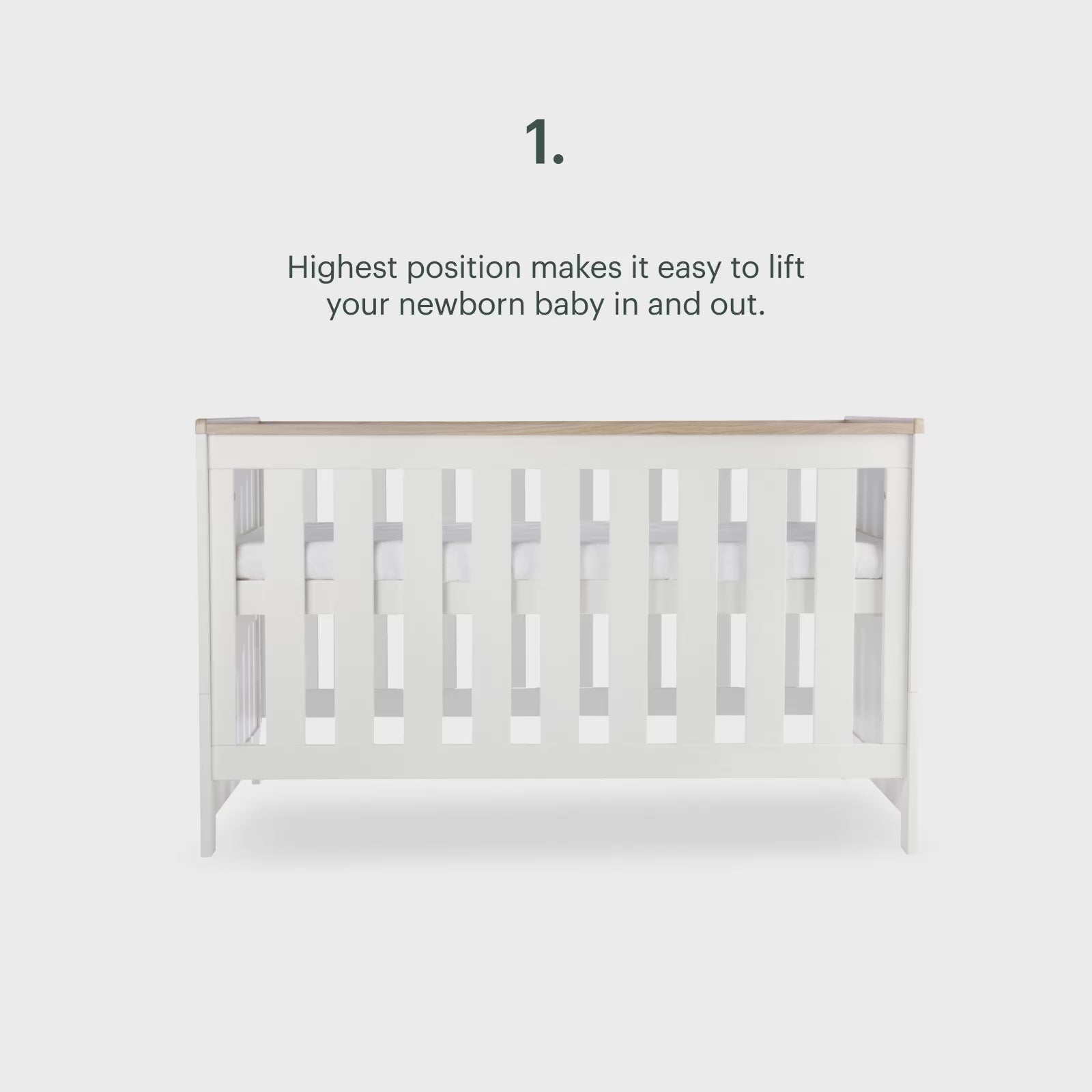 CuddleCo Burford cot bed in white with oak trim.