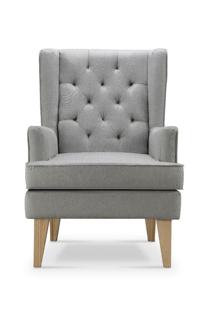 A high back grey rocking chair upholstered fabric, featuring a tufted back and sturdy hardwood legs.